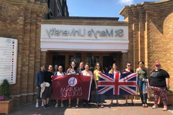 学生们举着电子游艺靠谱平台旗和英国国旗站在圣. 玛丽的大学